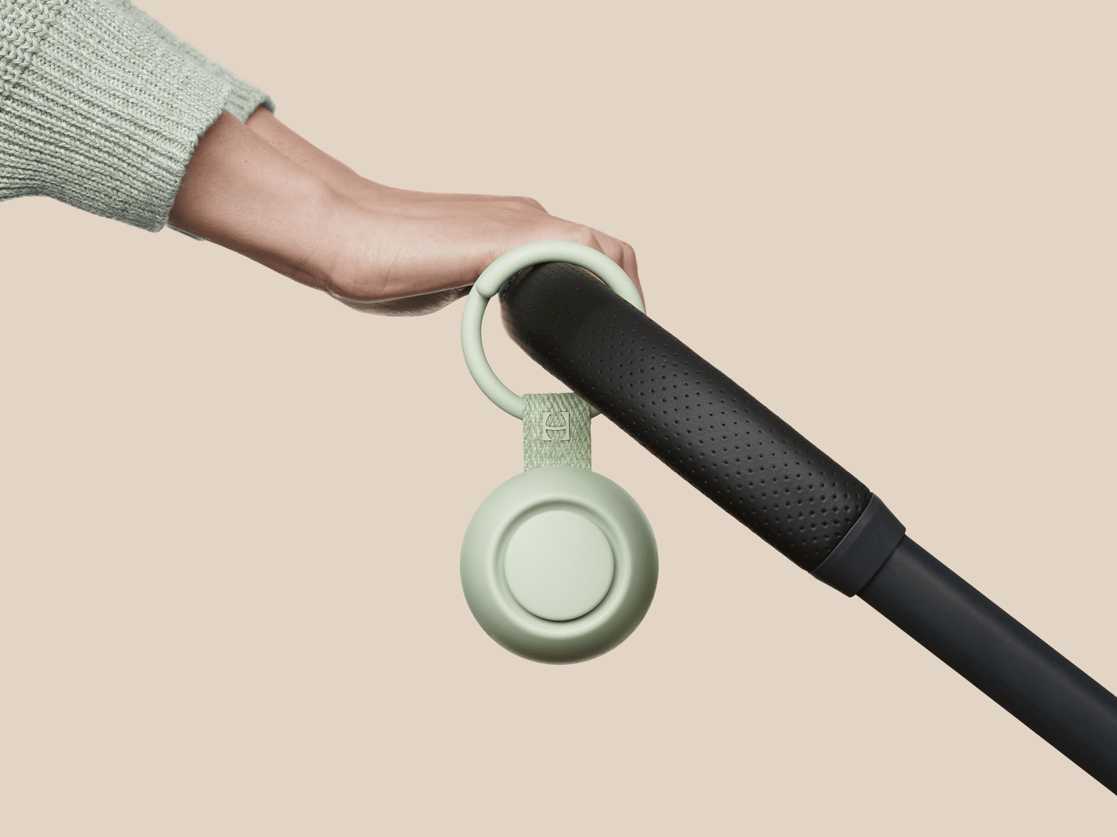 Hatch Go mint colorway clipped to baby stroller