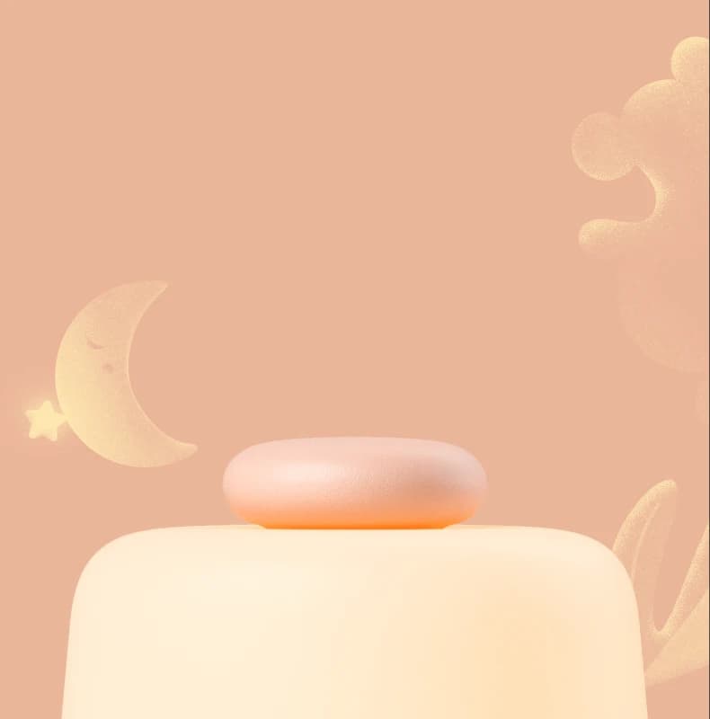 Closeup of Hatch Baby top button on a moon and cloud background